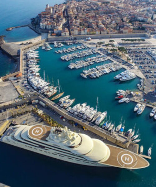 Aerial of a megayacht docked at a marina in Cannes.